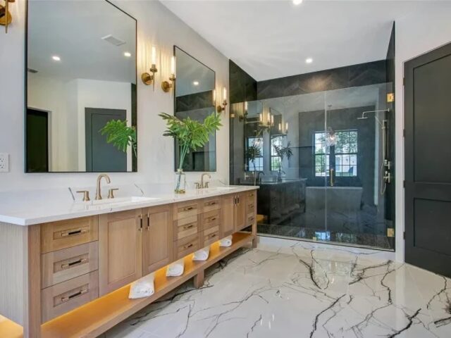 Double bathroom vanity with marble and brass by Mastery Cabinetry
