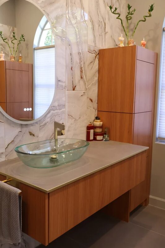 Bathroom cabinetry with round mirrors and tall units