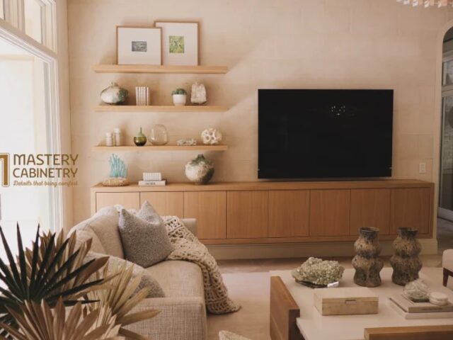 Living room built-in with floating shelves and TV wall by Mastery Cabinetry